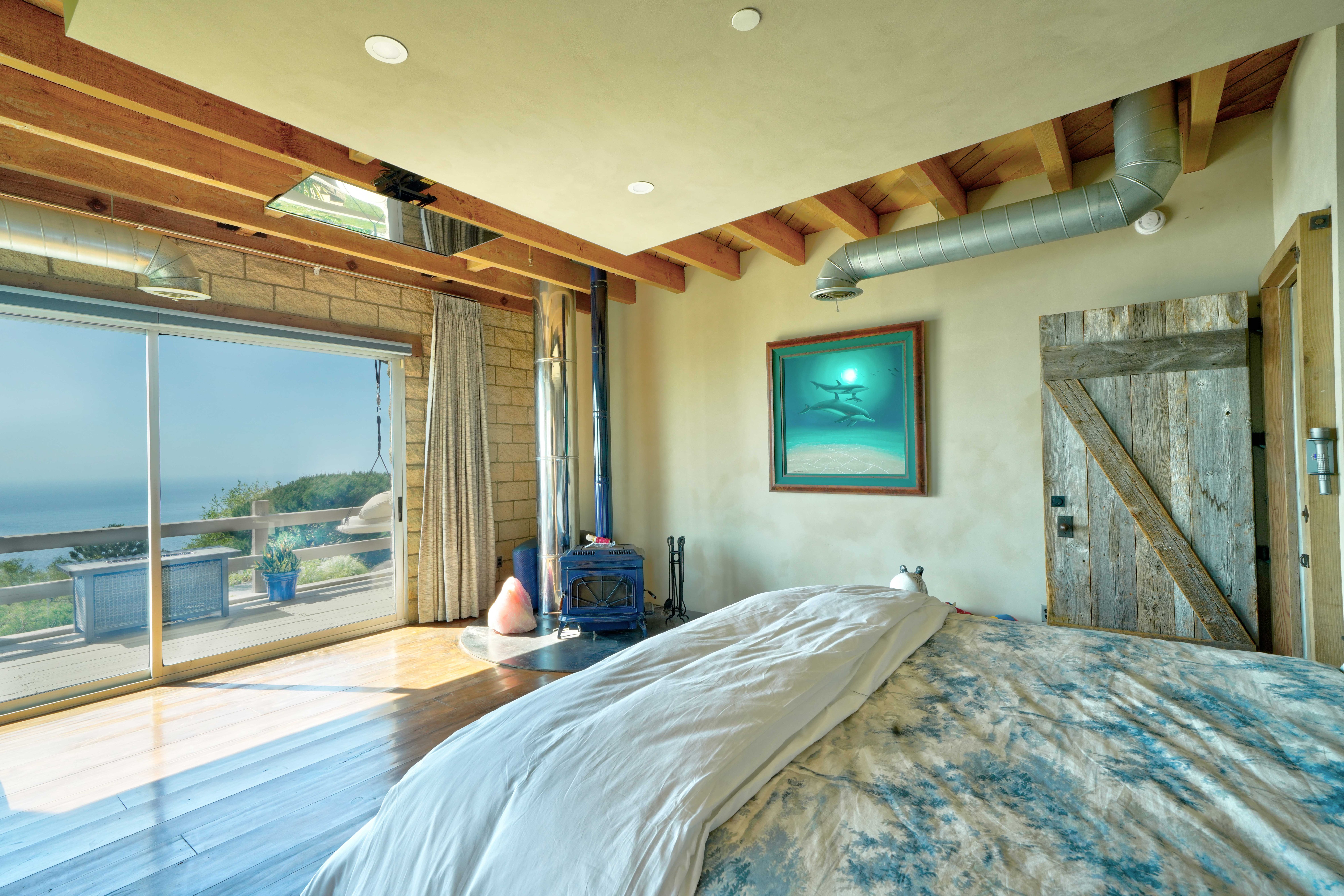 Bedroom with fireplace and ocean view
