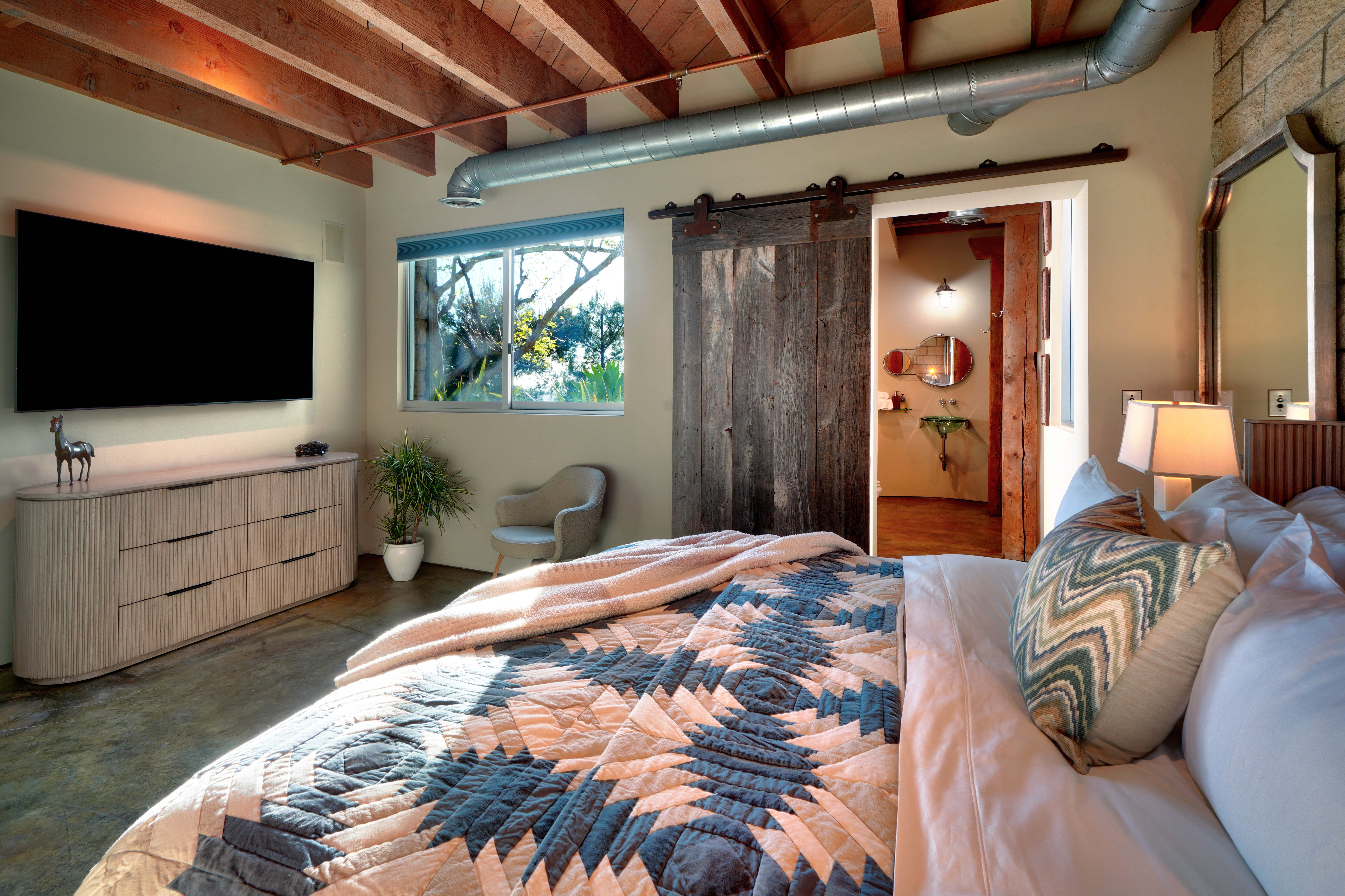 Bedroom with reclaimed wood barn door